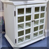 F25. White cabinet with glazed doors. 29”h x 28”w x 20”d 
